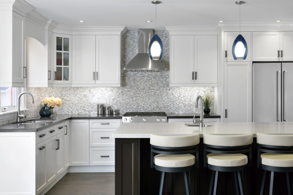 mosaic backsplash, retro pendant lights, kitchen reno, main floor reno, curved stairs, two tone kitchen cabinets, two tone kitchen countertop, hardwood throughout, prep sink, main sink, fireplace, stainless steel chimney hood, slide in range, 36&quot; fridge