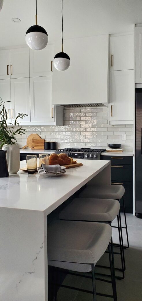 kitchen reno, bathroom reno, powder room, brizo, mitzi, waterfall, custom kitchen, ikea kitchen, two tone kitchen, kitchen pendants, brass hardware, artisan backsplash, caesarstone, kohler, tile floor, custom hood